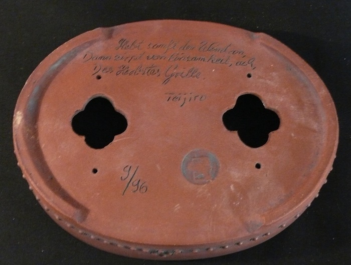 Bottom of a bonsai pot with large drainage holes